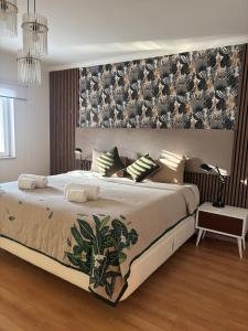 a bedroom with a large bed with a large wall at Pool, BBQ & Soccer Villa in Aroeira +62 photos