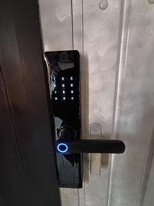 a remote control with a blue light on a door at Eva hostel & chill Ayacucho in Ayacucho