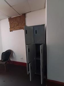 a room with a refrigerator and a chair in it at Eva hostel & chill Ayacucho in Ayacucho