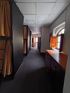 a hallway of a room with a kitchen and a dining room at Eva hostel & chill Ayacucho in Ayacucho