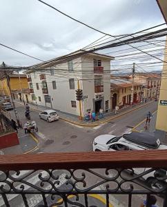 a view from a balcony of a city street with cars at Eva hostel & chill Ayacucho in Ayacucho +14 photos