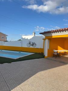 a bike parked on the side of a house at Pool, BBQ & Soccer Villa in Aroeira