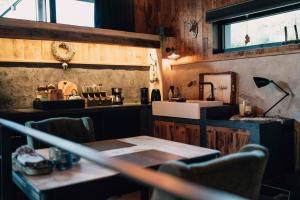 a kitchen with a table and a sink and a counter at Le Loft "L'Atelier", petit déj inclus in Fauvillers