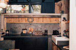a kitchen with a black counter top and a sink at Le Loft "L'Atelier", petit déj inclus in Fauvillers