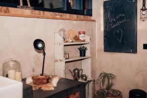 a room with a desk with a chalkboard on the wall at Le Loft "L'Atelier", petit déj inclus in Fauvillers +13 photos