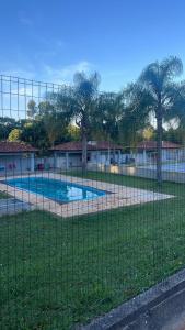 a fence in front of a swimming pool at Apartamento com piscina in Ponta Grossa