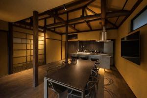 a kitchen with a table and chairs in a room at 宮島 Shinwa in Miyajima +16 photos