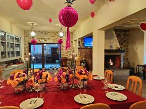 a dining room with a table with flowers and candles at Casa D'Augusta - Agroturismo in Miranda do Douro +63 photos