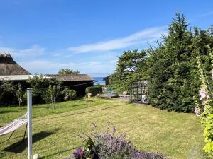 a garden with a hammock in the yard at 6 person holiday home in Rude in Rude