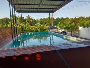 a swimming pool on top of a house at Maruay in Suratthani
