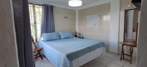 a bedroom with a bed with blue pillows and a window at Ziruma in Valle de Anton +31 photos