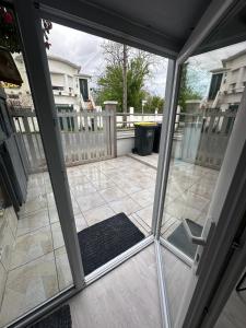 a sliding glass door of a patio with a rug at Appartement familial de 60 M2 in Angoulême