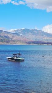 a boat sitting in the middle of a large body of water at Le Figuier du Lac Bin elouidane in Bine el Ouidane