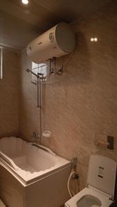 a bathroom with a toilet and a bath tub and a camera at Sheba Palace Apartment in Addis Ababa +59 photos