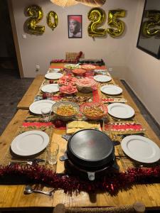 a table with plates and food on top of it at Le Figuier du Lac Bin elouidane in Bine el Ouidane