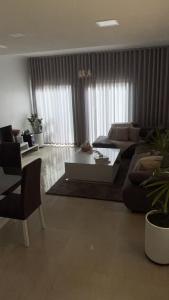 a living room with a couch and a coffee table at Condominio hortencia in Viana