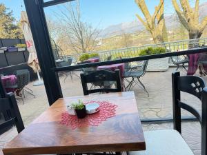 a table and chairs on a balcony with a view at Hotel corner in Bërzhitë