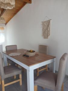 a table with chairs and a bowl of fruit on it at merlomar1 in Merlo +8 photos