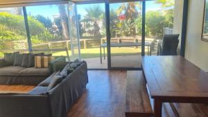 a living room with a couch and a table at Apartment In Paradise in Hawks Nest