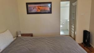 a bedroom with a bed and a picture on the wall at Apartment In Paradise in Hawks Nest