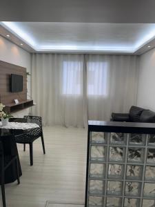 a living room with a table and a television at AP ALPHA 5 STAr in Vespasiano