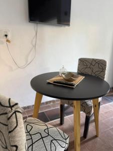 a table and two chairs and a table with a plate on it at Merlo mar 2 in Merlo