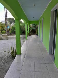 an empty hallway of a building with green walls at Pousada Elis Regina in Guaraqueçaba