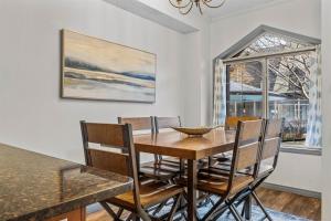 a dining room with a table and chairs and a window at Mystic Springs #108 - Hot Tub and Pool, Pets managed by Little Sister Getaways in Canmore