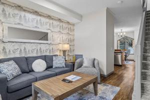 a living room with a couch and a table at Mystic Springs #108 - Hot Tub and Pool, Pets managed by Little Sister Getaways in Canmore