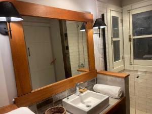 a bathroom with a sink and a mirror at eastwood in San Carlos