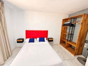a bedroom with a large bed with a red headboard at casa villa azul 1 in Tanti