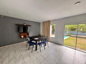 a dining room with a table and blue chairs at casa villa azul 1 in Tanti