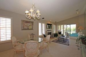 a dining room and living room with a chandelier at Balcony-Views-Country Club Living-VV667 in Palm Desert