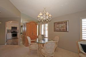 a dining room with a table and chairs and a chandelier at Balcony-Views-Country Club Living-VV667 in Palm Desert