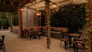 a patio with tables and chairs under a pergola at Sheba Palace Apartment in Addis Ababa