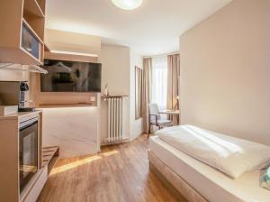 a hotel room with a bed and a kitchen at Altstadt Hotel in Würzburg