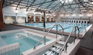 a large indoor swimming pool with a large pool at The Charming Cracker! in Auckland