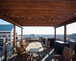 a table and chairs on a balcony with a view at Stylish Loft, Walk to WORLD CUP! in Atlanta