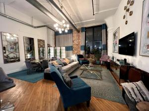 a living room with a couch and a tv at Stylish Loft, Walk to WORLD CUP! in Atlanta