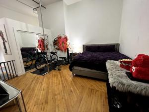 a bedroom with a bed and a bike in a room at Stylish Loft, Walk to WORLD CUP! in Atlanta