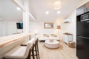 a living room with white furniture and a table at The Margaret Suite in Key West