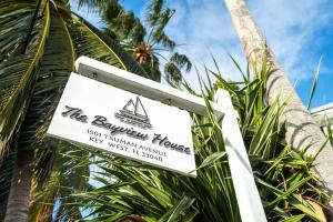 a sign for the burrow house on a palm tree at The Margaret Suite in Key West