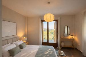 a bedroom with a bed and a large window at Epidavros View Villas in Ancient Epidauros