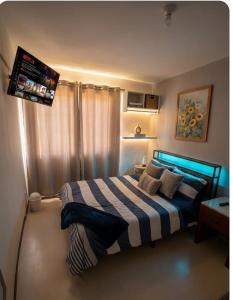 a bedroom with a bed with a tv on the wall at DePA DRAGON in Tizayuca