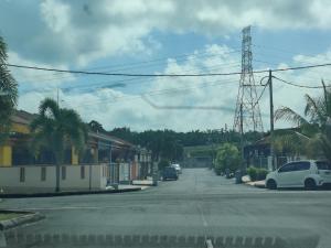 a street with cars parked on the side of the road at AZALEA Homestay Segamat in Segamat