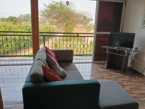 a living room with a couch and a television at Aptos luminoso y cómodos en barrio tranquilo y un poco rural in Villavicencio