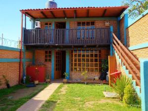 a brick house with a balcony on top of it at CABAÑA Adán y Eva en Zacatlán in Zacatlán
