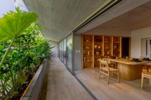 a large room with a table and some plants at Lulu Condesa by Capitalia in Mexico City