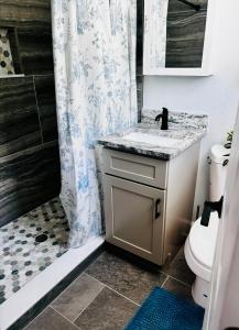 a bathroom with a sink and a shower with a toilet at The Monterey Beach Resort in St. Pete Beach +37 photos