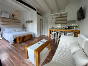 a bedroom with a bed and a living room at Laguna y Tierra in Chascomús